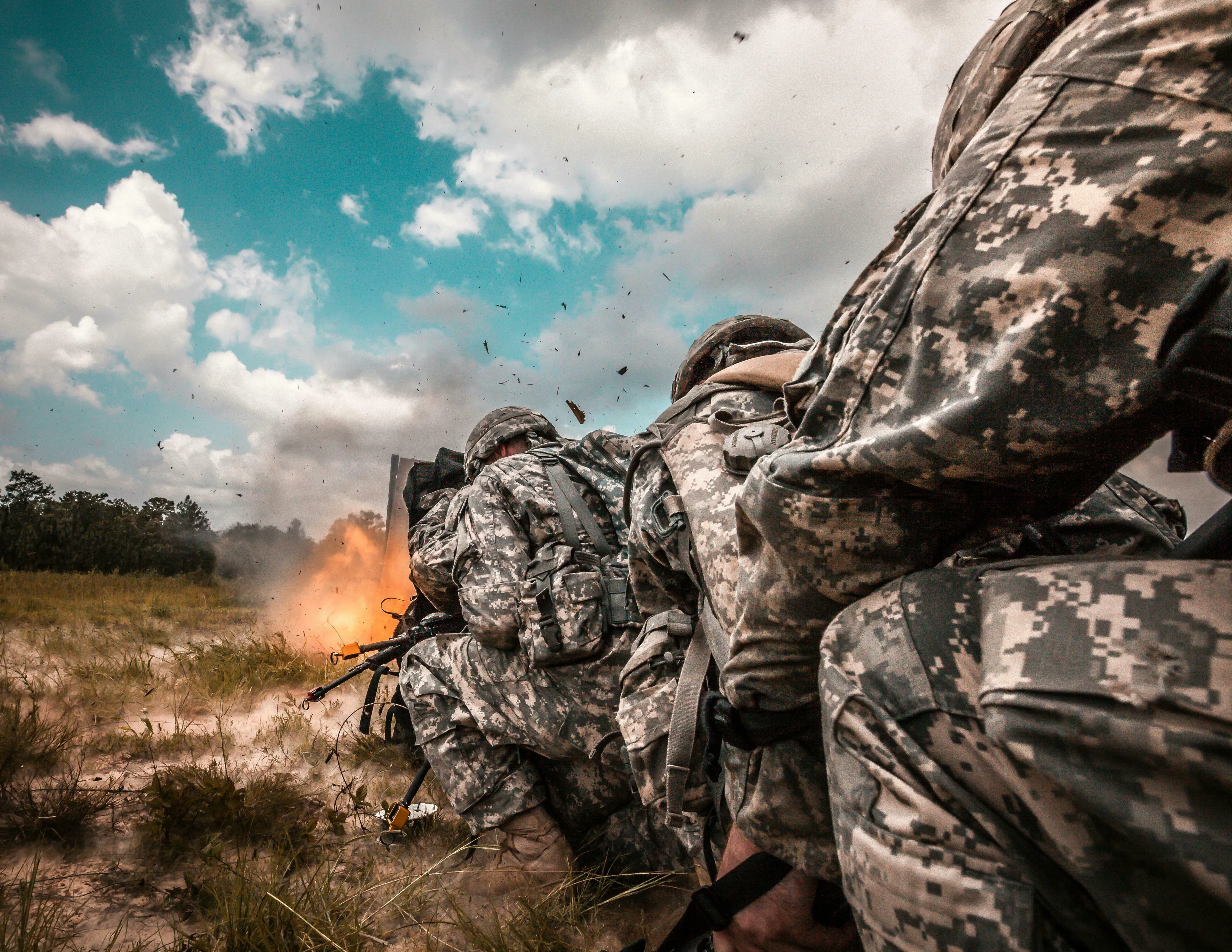 Soldiers in camouflage uniforms firing a weapon, with an explosion visible. General Knowledge Quiz.