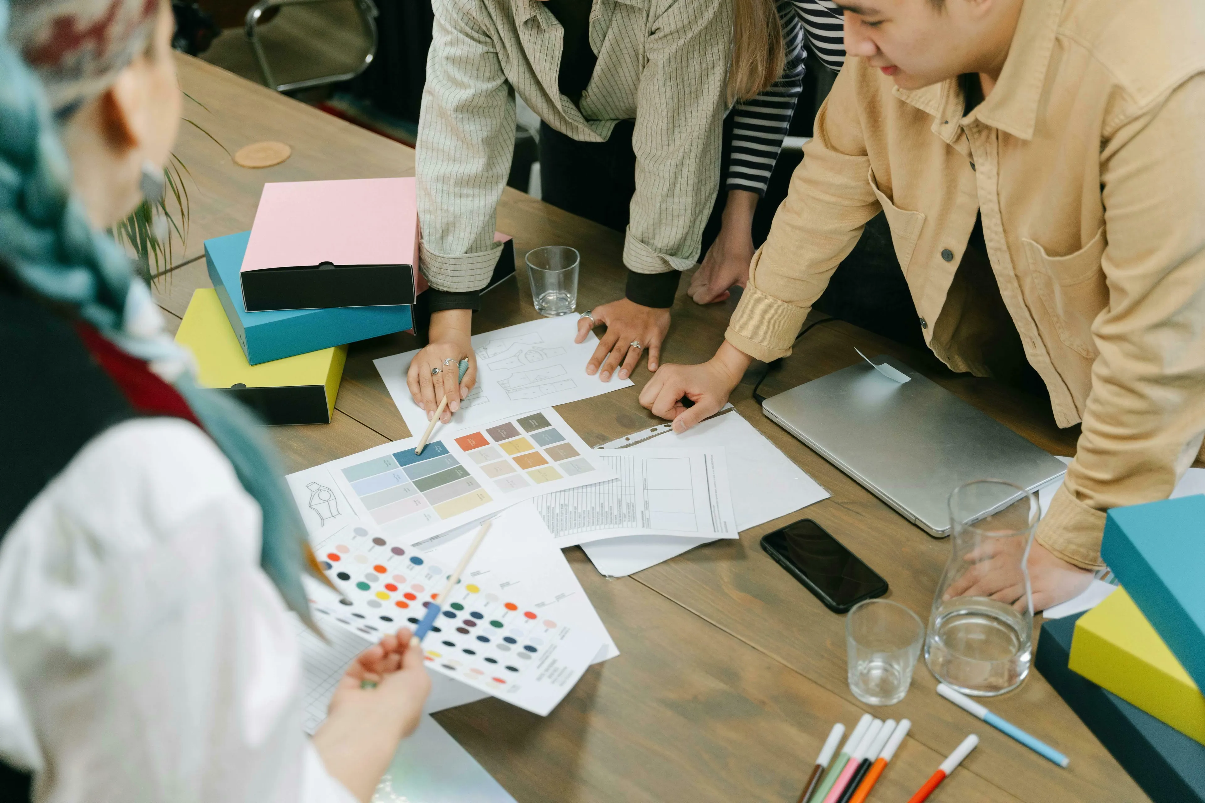 Team collaborating on designs, discussing color palettes and ideas for a brand-new project. What's your procrastination type?