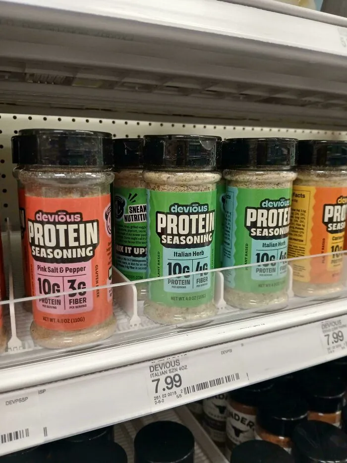 Spice jars on a store shelf displaying questionable food combos like protein seasoning