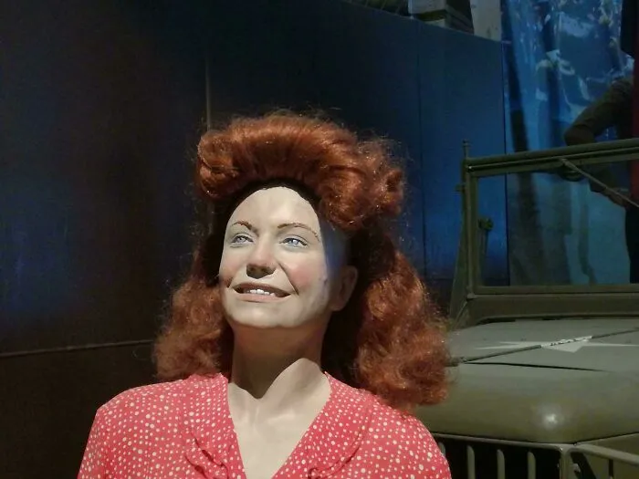 Celebrity wax figure with big red curly hair smiling in polka dot dress