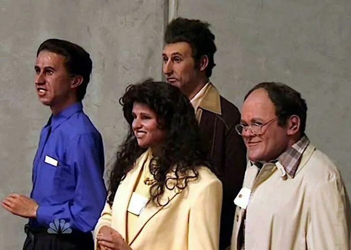 Group of four wax figures of television characters in odd poses