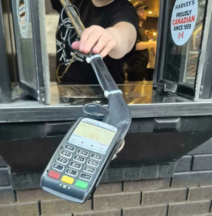 My Local Harvey's (Canadian Burger Place) Zipties Their Terminal To A Hockey Stick For The Drive Through