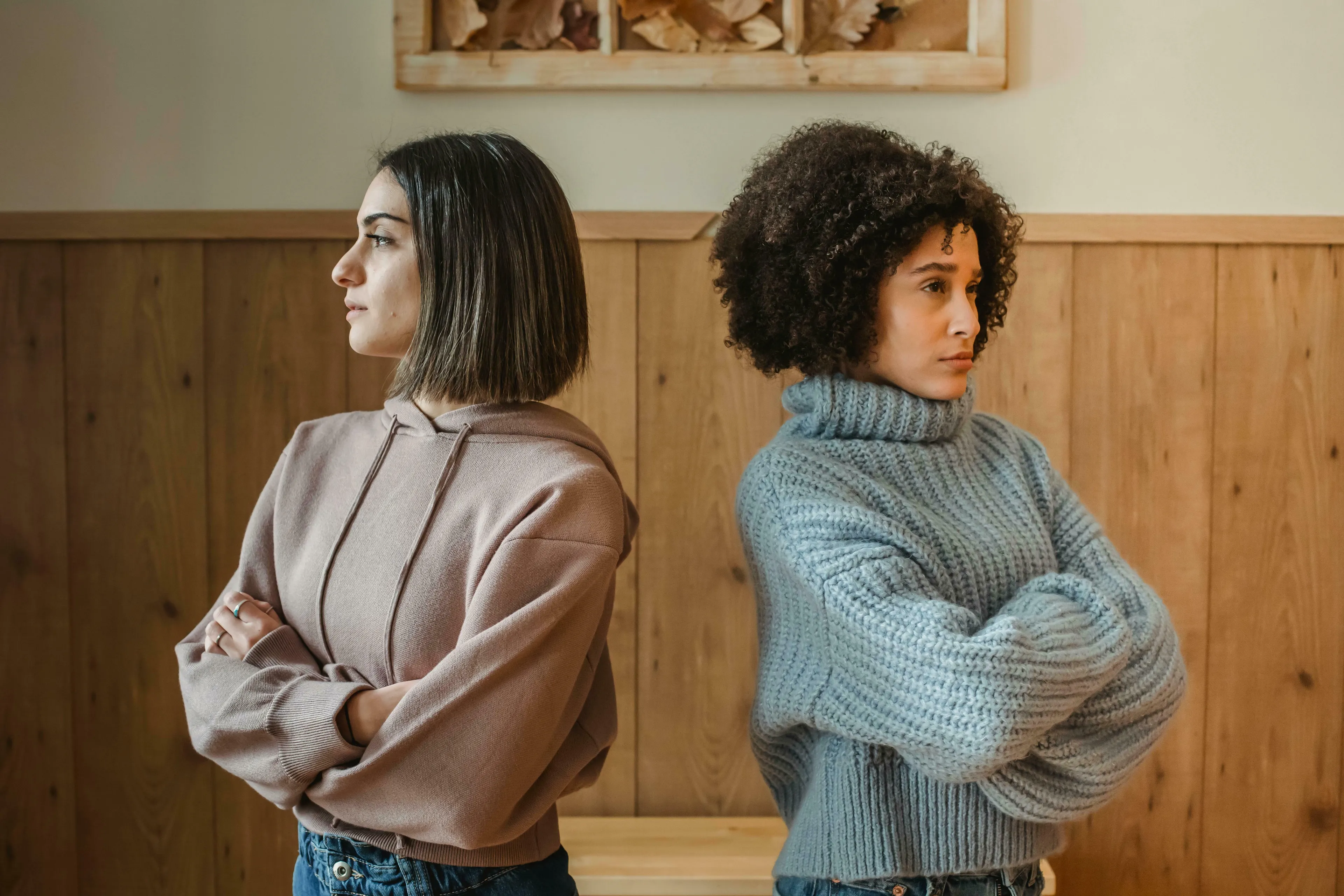 Two women turn their backs to each other, looking unhappy. How do you usually feel after an argument?