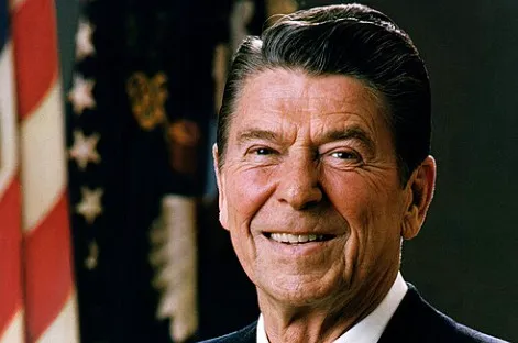 Former U.S. President Ronald Reagan smiling in a professional portrait. Test your general knowledge quiz skills.