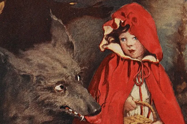An illustration of Little Red Riding Hood looking wide-eyed at a snarling wolf with bared teeth, a basket in her hand.