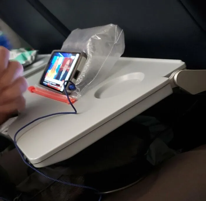 Old Dude In The Seat Next To Me On My Flight Used A Partially Inflated Baggy As A Phone Stand... Brilliant