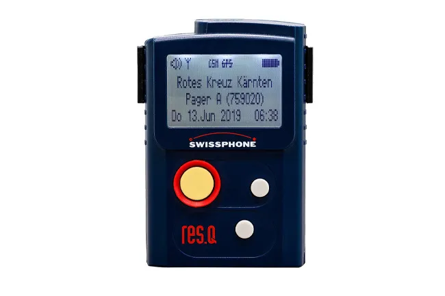 A blue Swissphone res.q pager on a white background, displaying Red Cross Kärnten and a message. A nostalgic old gadget.