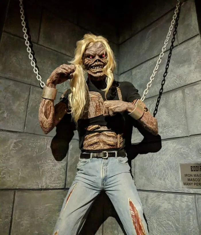 Scary zombie-like celebrity wax figure with long blonde hair and chains
