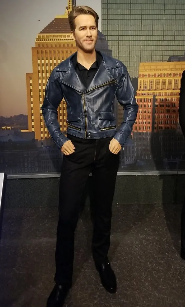 Celebrity wax figure wearing a blue leather jacket and black pants