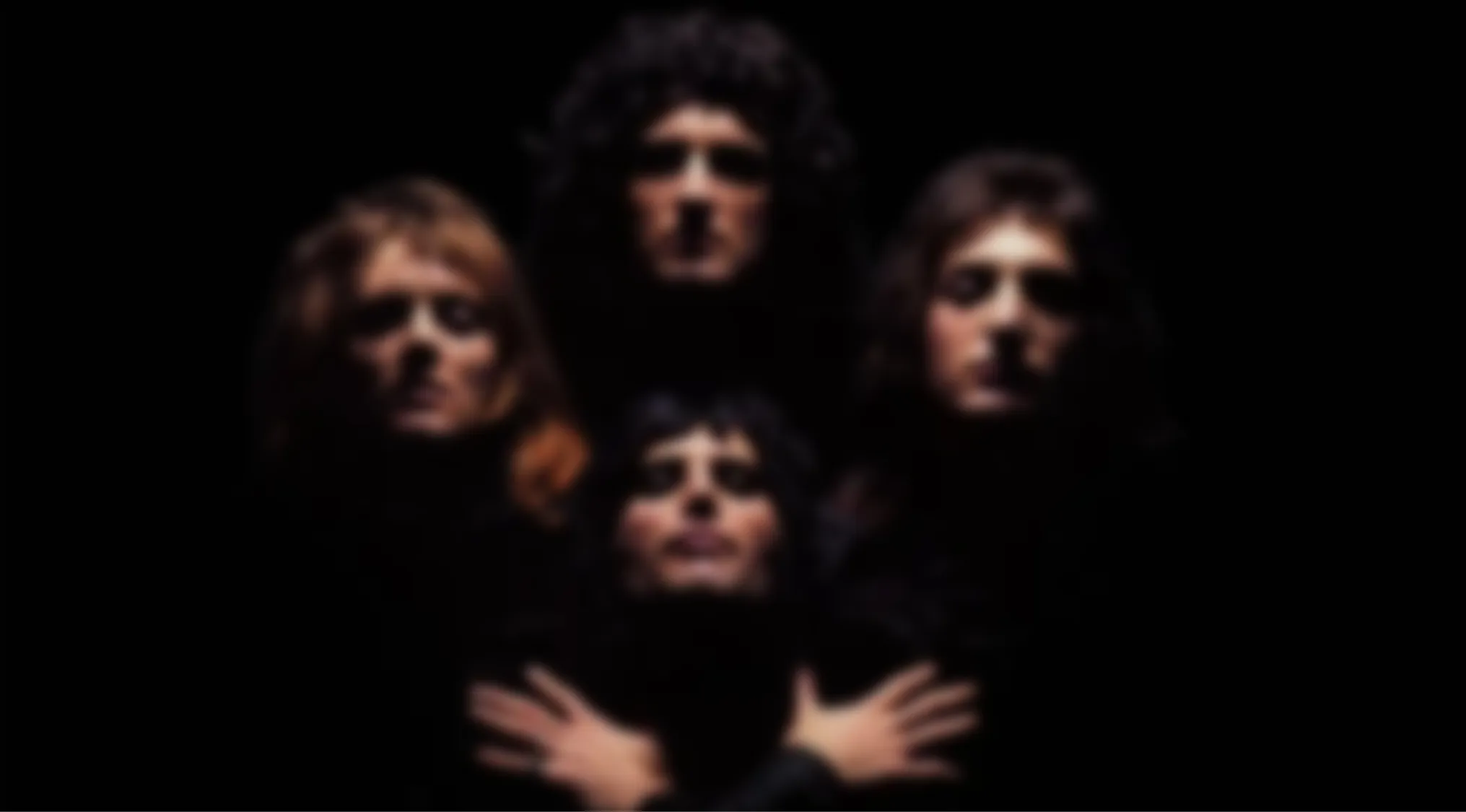 Four blurry figures on a black background. Can you identify this Blurry Music Videos Quiz image?