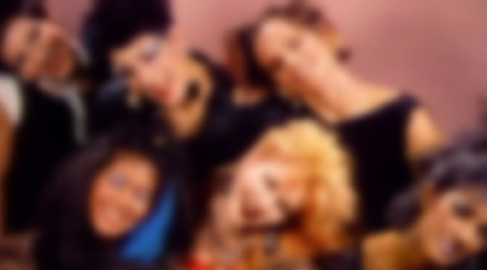 A blurry music video quiz image shows several people with diverse hair colors and styles, their faces indistinct.