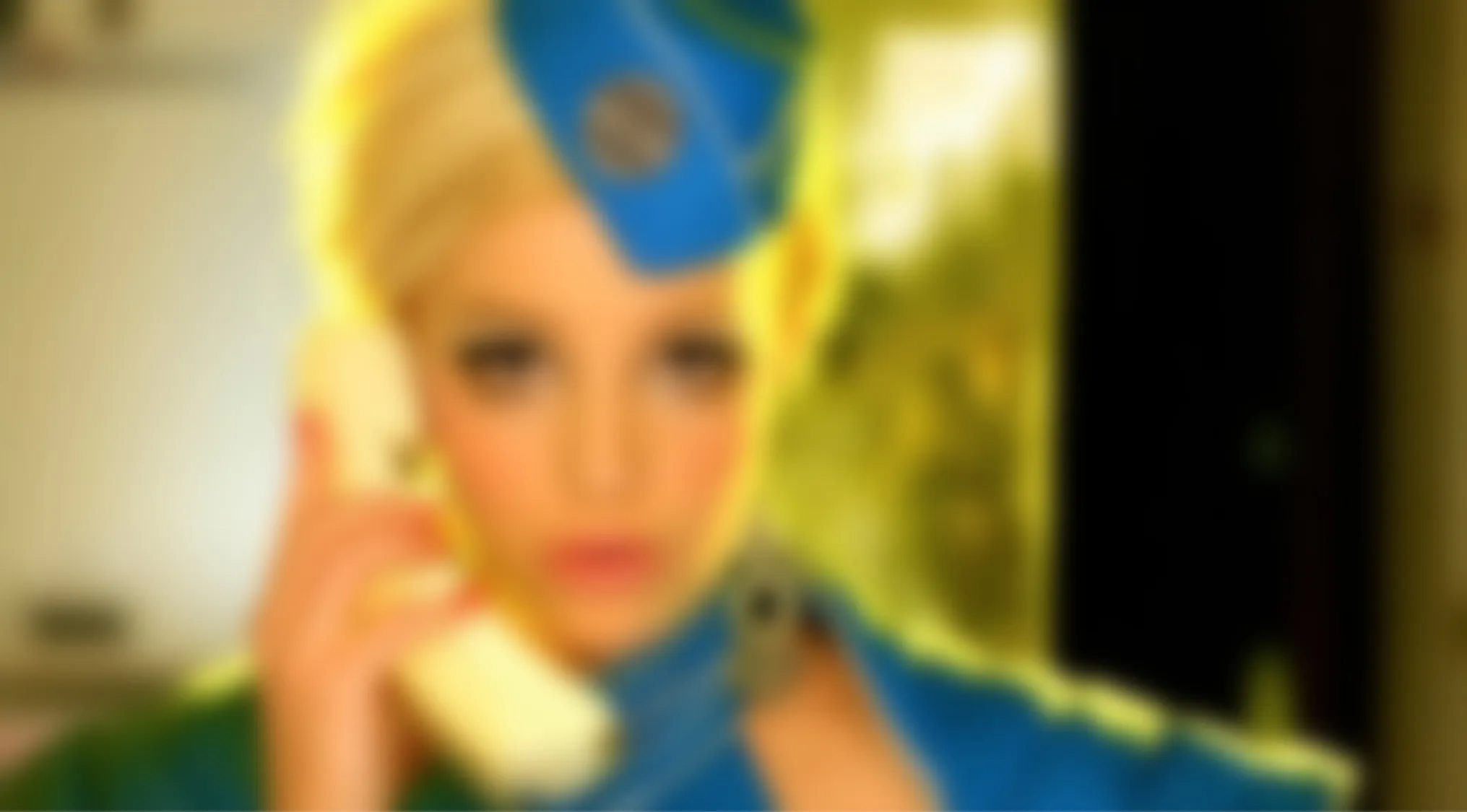 Blurry Music Videos Quiz: A blonde woman in a blue hat and uniform, holding a phone to her ear. Which Britney Spears music video is this?