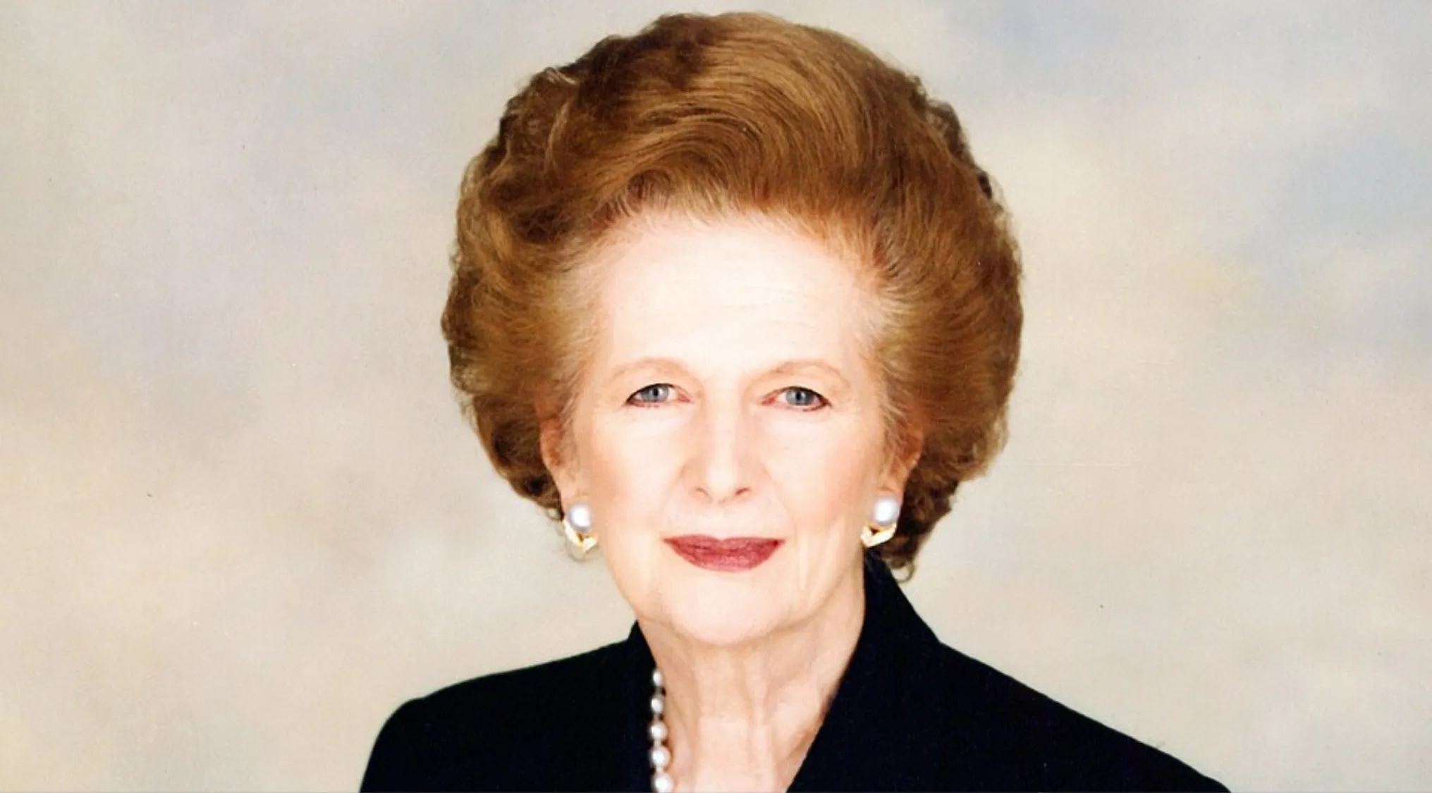 Portrait of Margaret Thatcher, Prime Minister of the United Kingdom in the 80s, wearing pearl earrings and necklace.