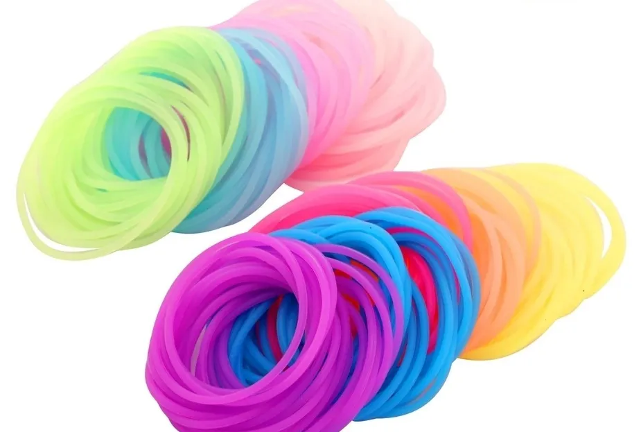 Colorful stacks of jelly bracelet accessories in vibrant neon pink, purple, blue, yellow, orange, and green hues.