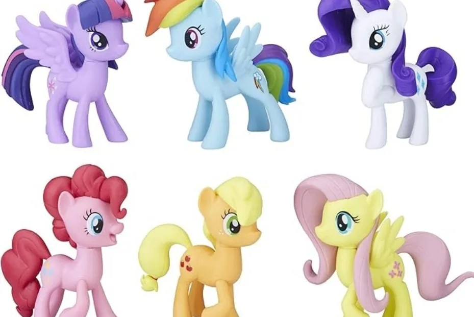 A collection of six colorful My Little Pony toy figures, including Twilight Sparkle, Rainbow Dash, Rarity, Pinkie Pie, Applejack, and Fluttershy.