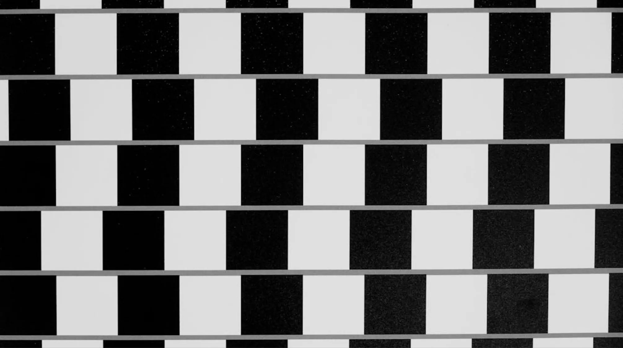 A black and white checkered pattern, evoking the iconic footwear brand from 80s pop culture for skateboarders.