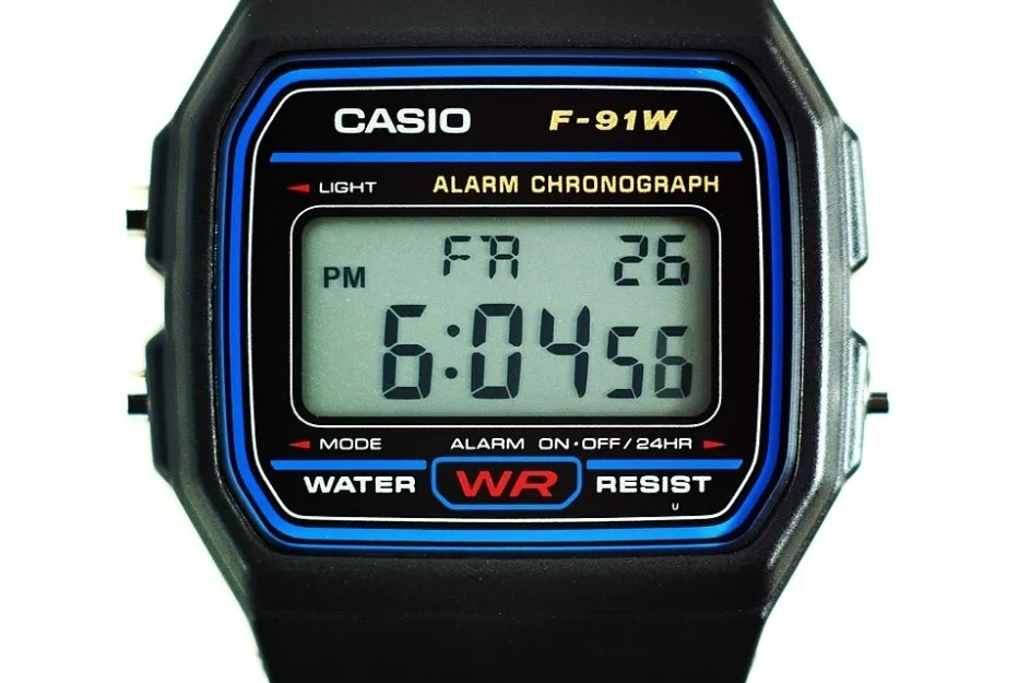 A close-up of a Casio F-91W digital watch, showcasing its iconic LCD screen with time, date, and alarm.