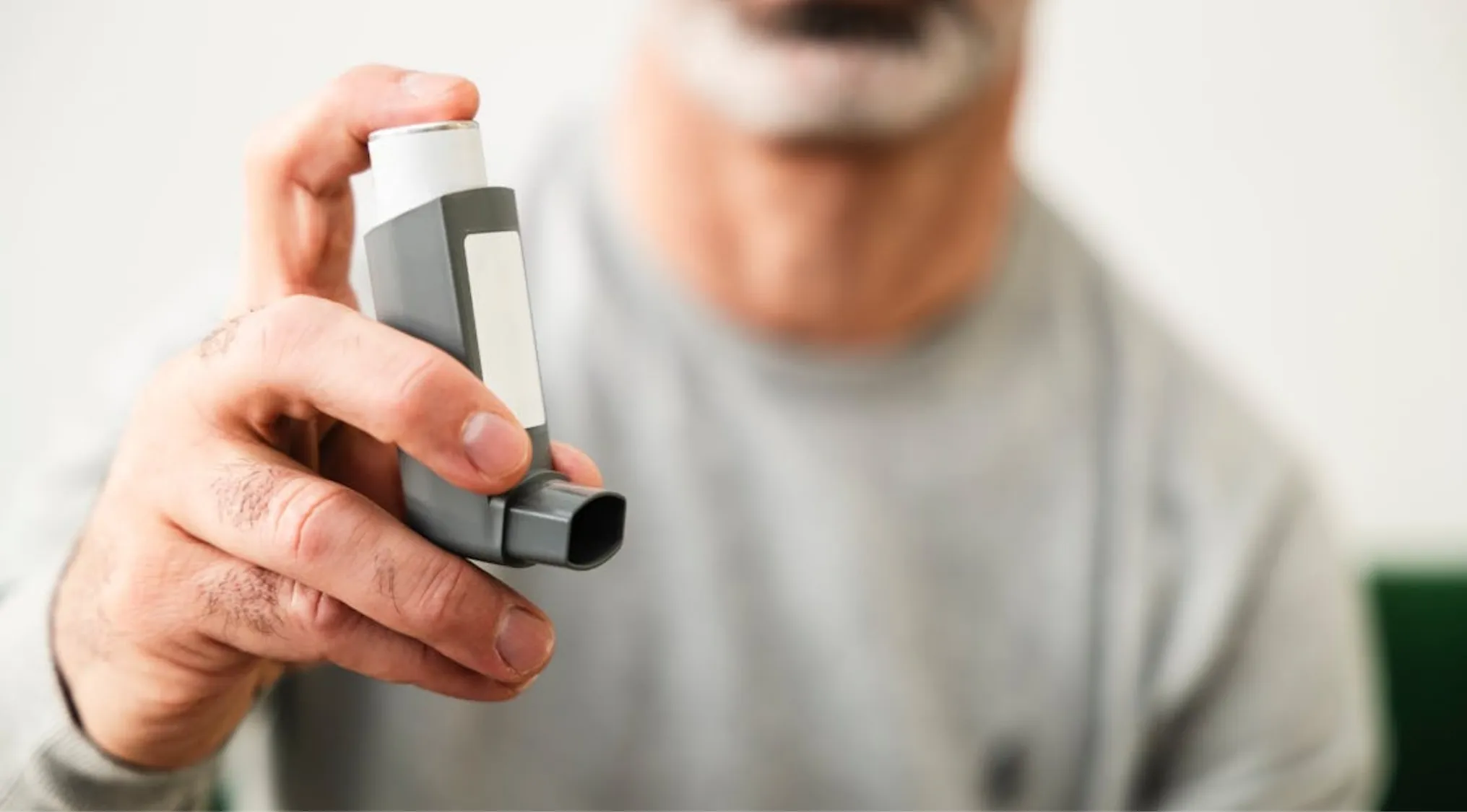 A man holds an asthma inhaler for First Aid in a Survival 101 scenario. During an asthma attack, a person’s airway is constricted.