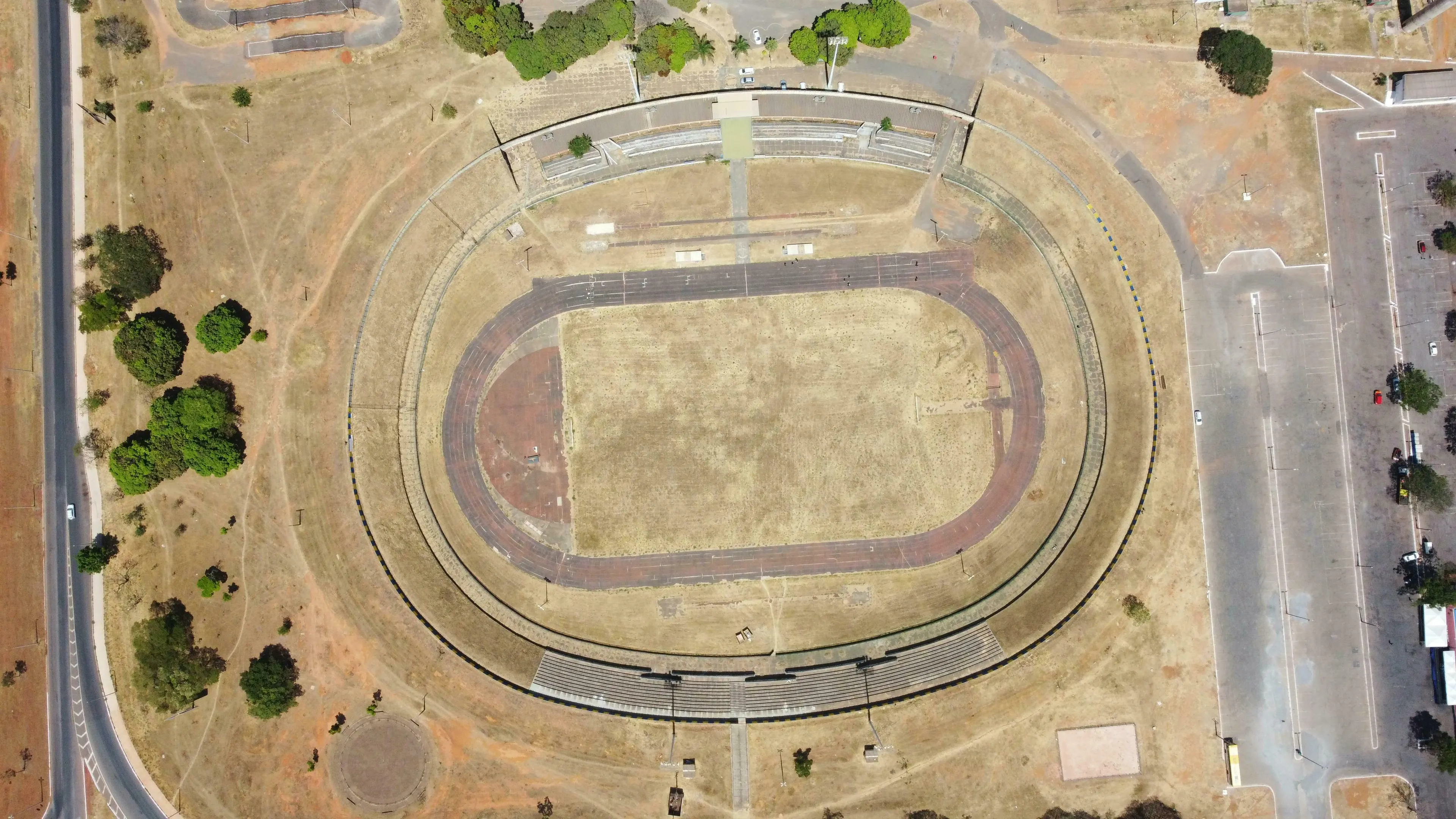 Aerial view of an abandoned stadium, representing the word "derelict" in a British vocabulary quiz.