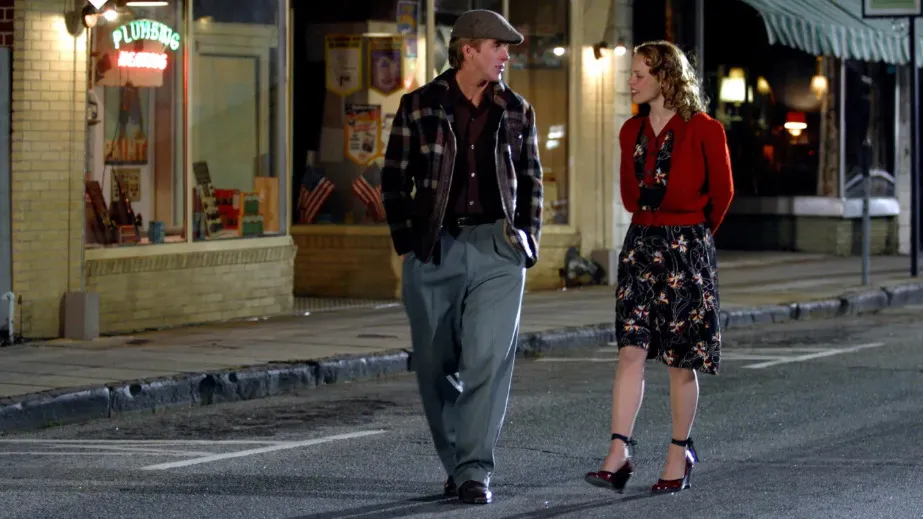 A couple, Noah and Allie from The Notebook, walking and talking on a street at night.