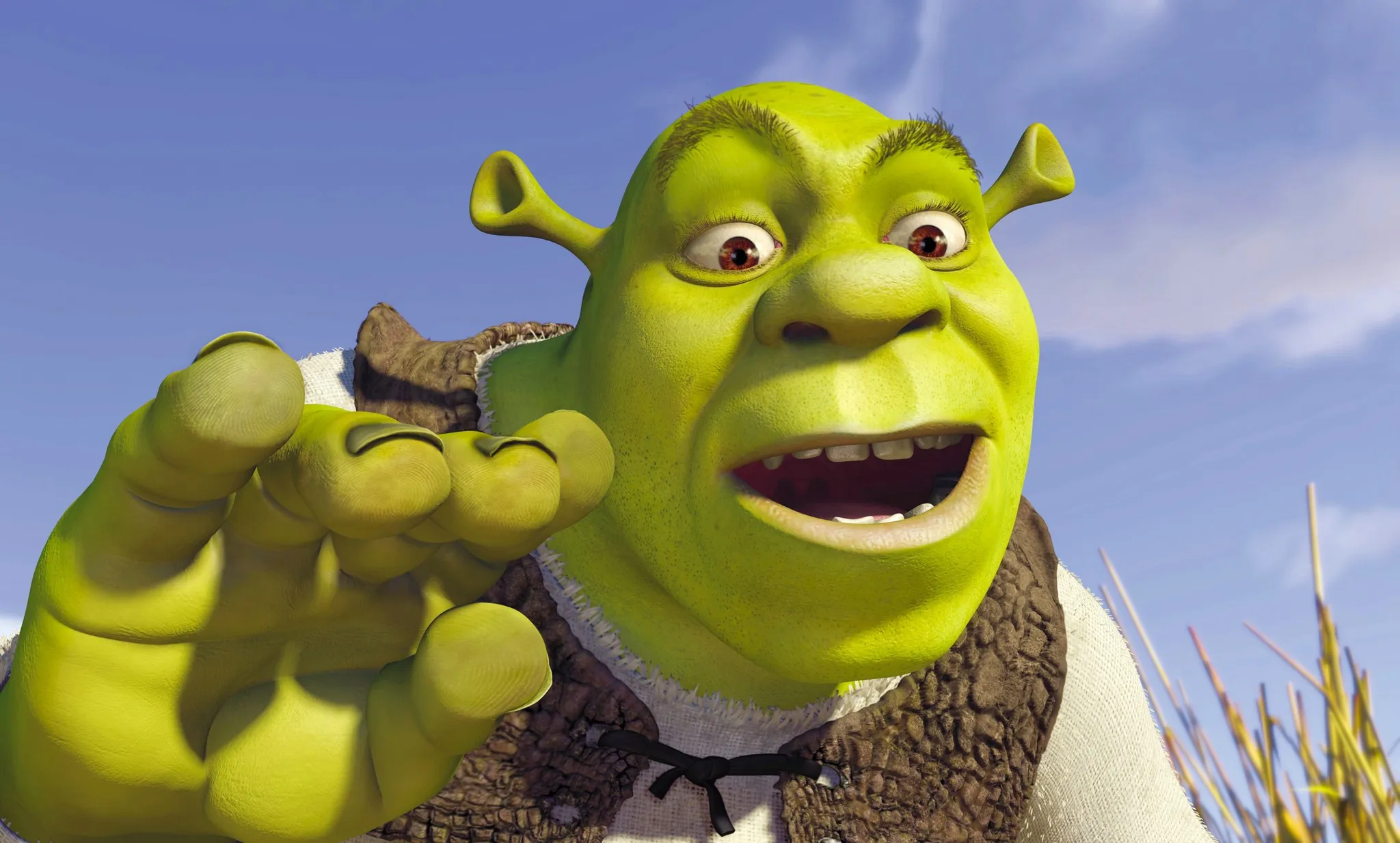 Animated fictional character Shrek, eyes wide and mouth open, extending a hand forward under a blue sky.