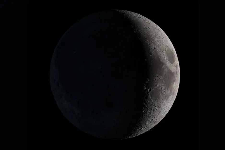 A stunning image of the Waning Crescent moon phase, displaying its dimly lit, cratered surface against a dark background.
