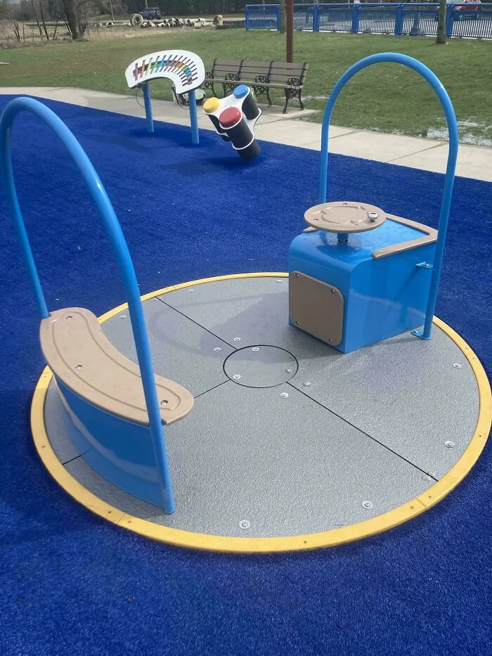 Playground Merry Go Round.  Turn The Knob On The Right Clockwise To Slowly Spin The Thing Through Great Effort And Stop After Less Than A Minute
