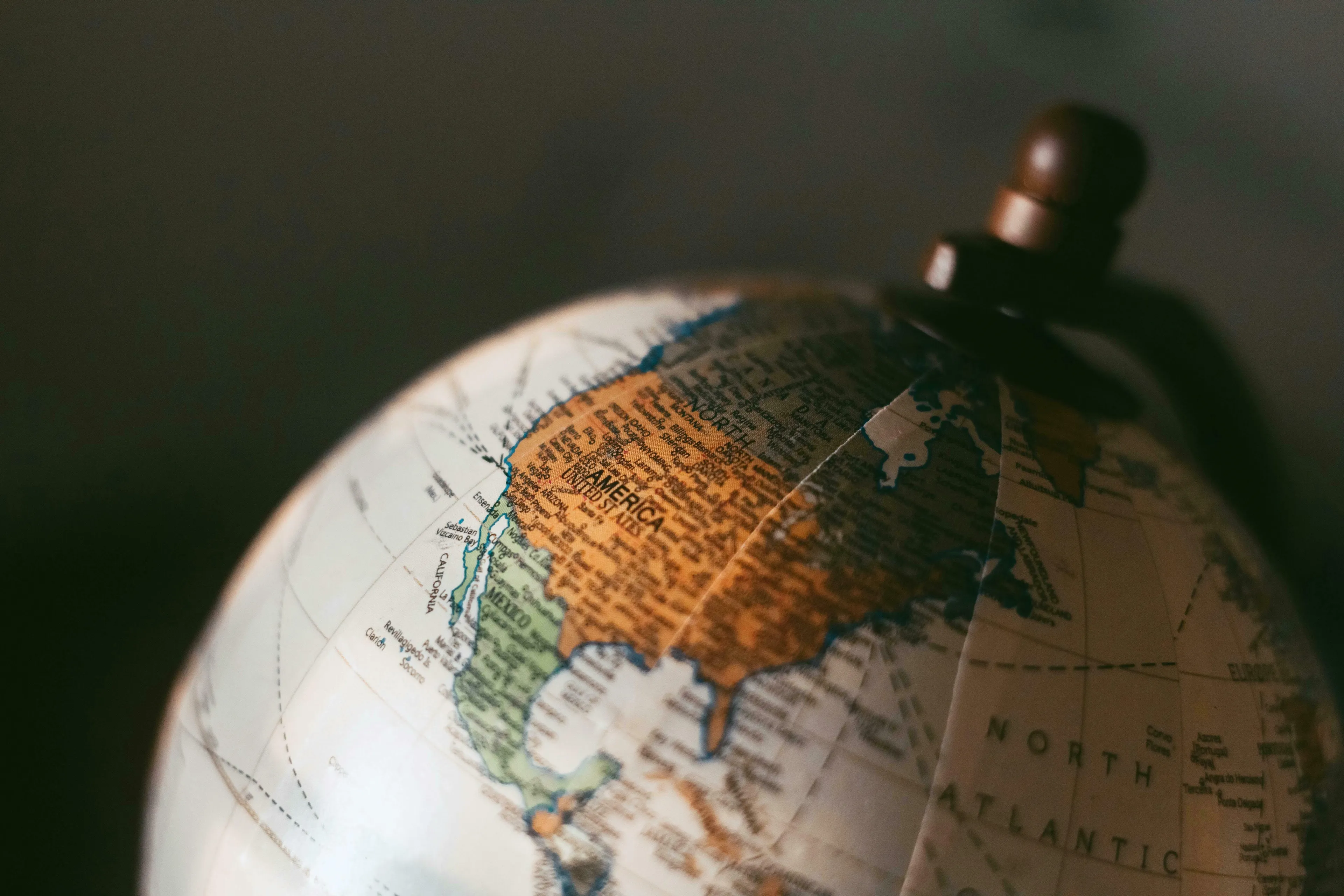 Close-up of a globe showing North America, highlighting US state capitals for a quiz.