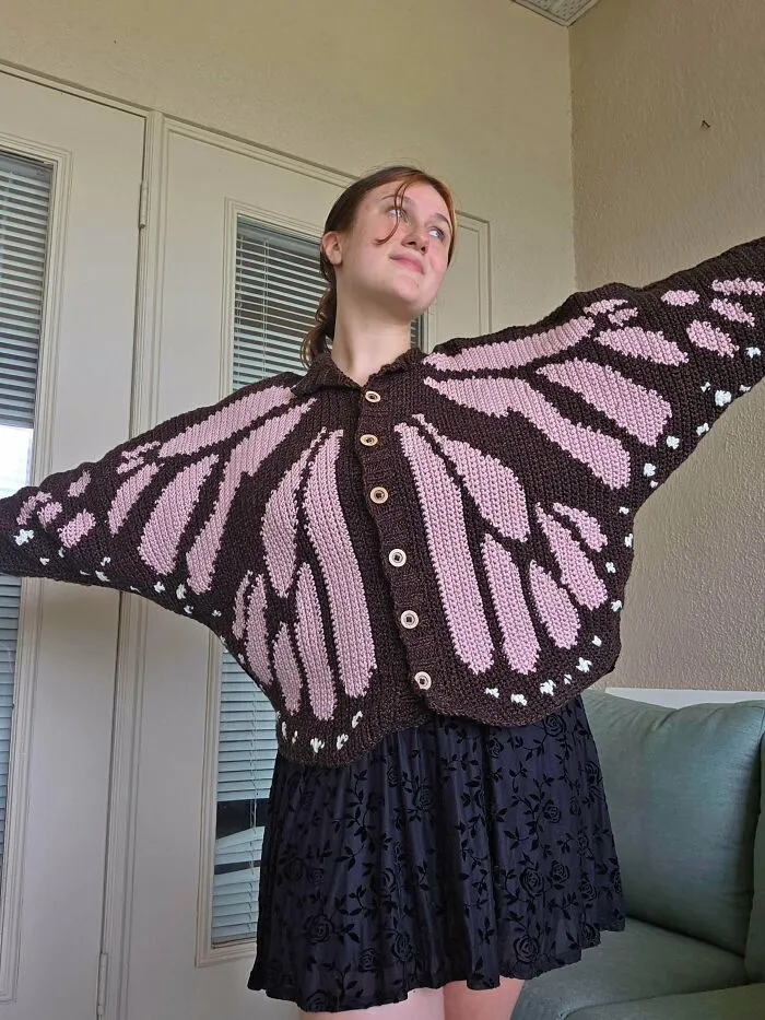 Butterfly wing patterned crochet cardigan worn by model, showcasing crochet talent