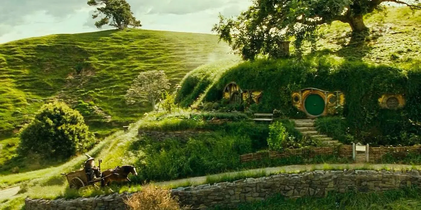 A picturesque view of The Shire with Bag End's green door, and a character riding in a horse-drawn cart.