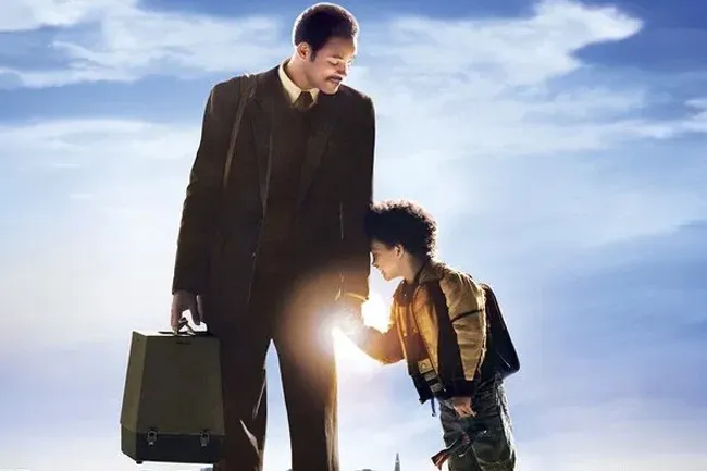 The Pursuit of Happyness film poster, featuring Will Smith and Jaden Smith against a blue sky, conveying hope.