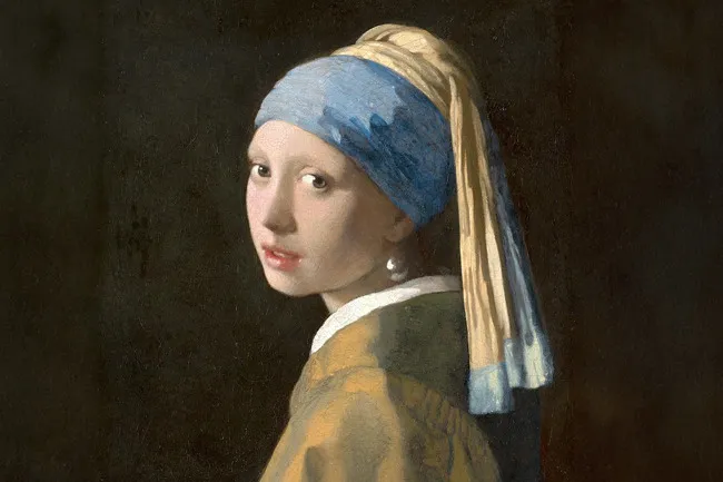 A famous painting, Girl with a Pearl Earring by Johannes Vermeer, a young woman in a blue and yellow turban looking over her shoulder.