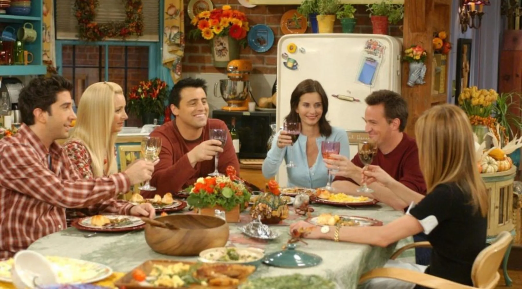 The cast of Friends enjoys Thanksgiving dinner, raising glasses. Test your general knowledge with our quiz!