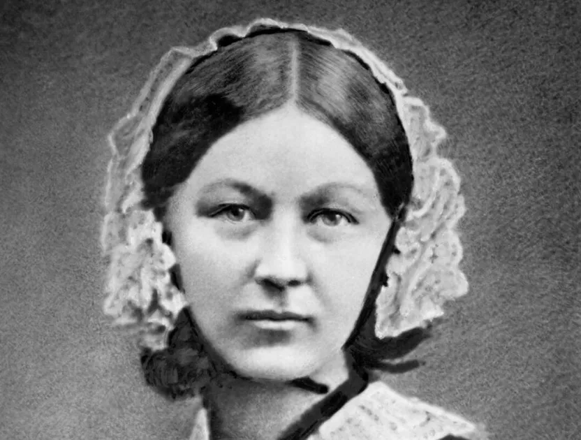 Florence Nightingale in a black and white portrait, wearing a lace cap and dark dress. A woman to win Nobel Prize.