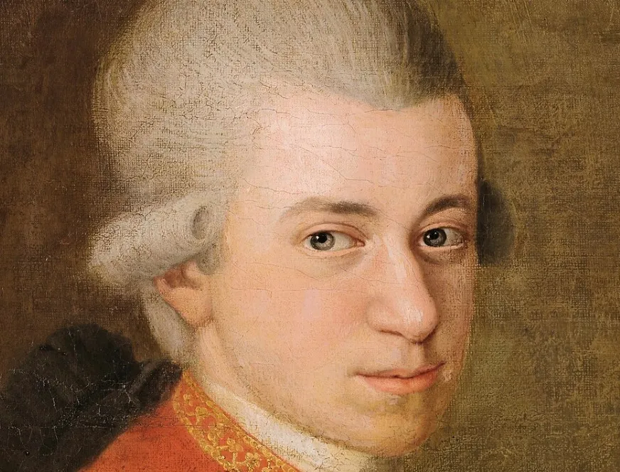 A detailed portrait of Wolfgang Amadeus Mozart with powdered white hair, looking directly at the viewer. Composer of classical music.