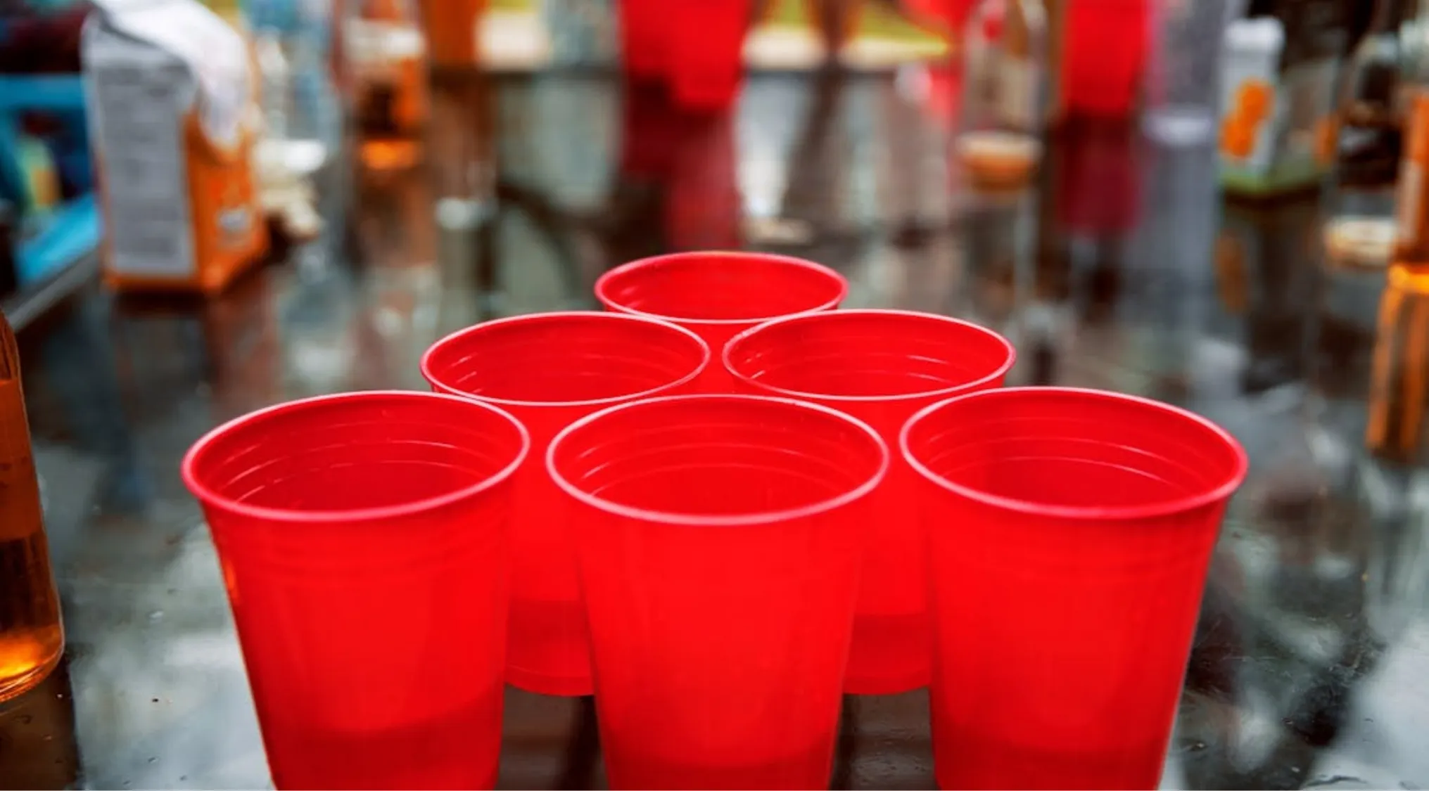 Red cups arranged on a table, ready for a game, embodying the Living In America party scene.