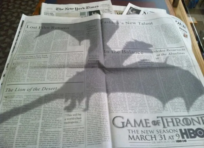 Game of Thrones shadow on a newspaper promoting new season on HBO