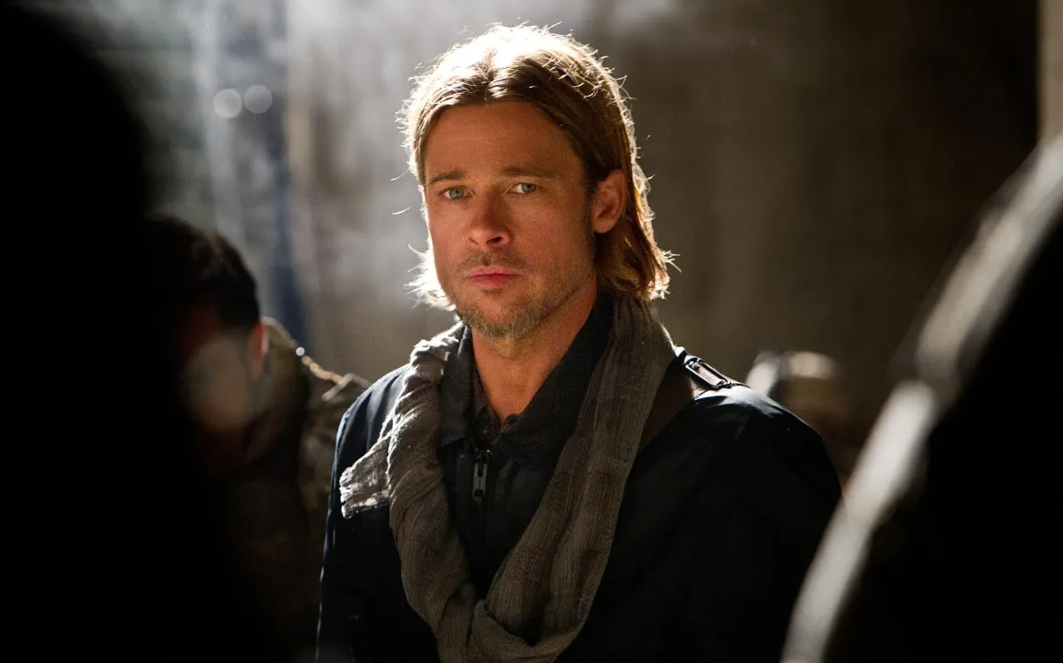 Hollywood actor Brad Pitt looking directly at the camera with blue eyes and a slight smile. Famous person close-up.
