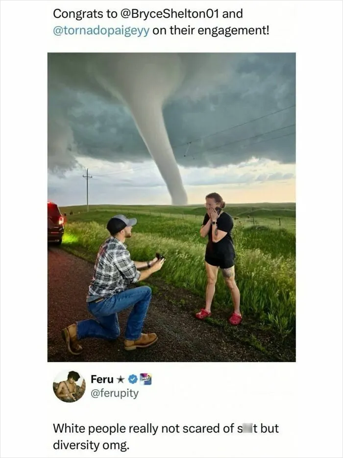 Man proposing to woman in front of a large tornado on a rural road