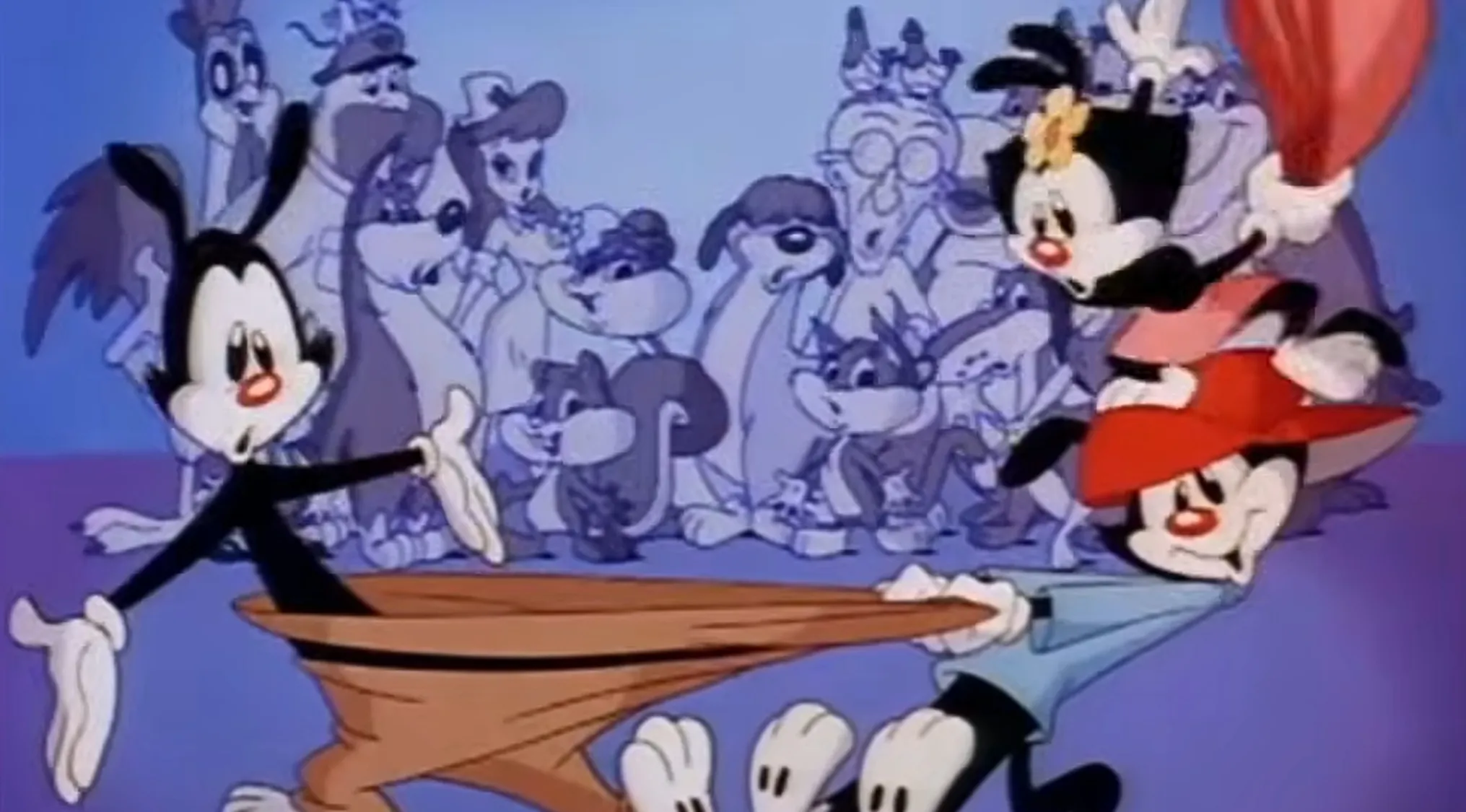 Saturday Morning Cartoons Trivia: Yakko, Wakko, and Dot in a chaotic scene with other cartoon characters in the background.
