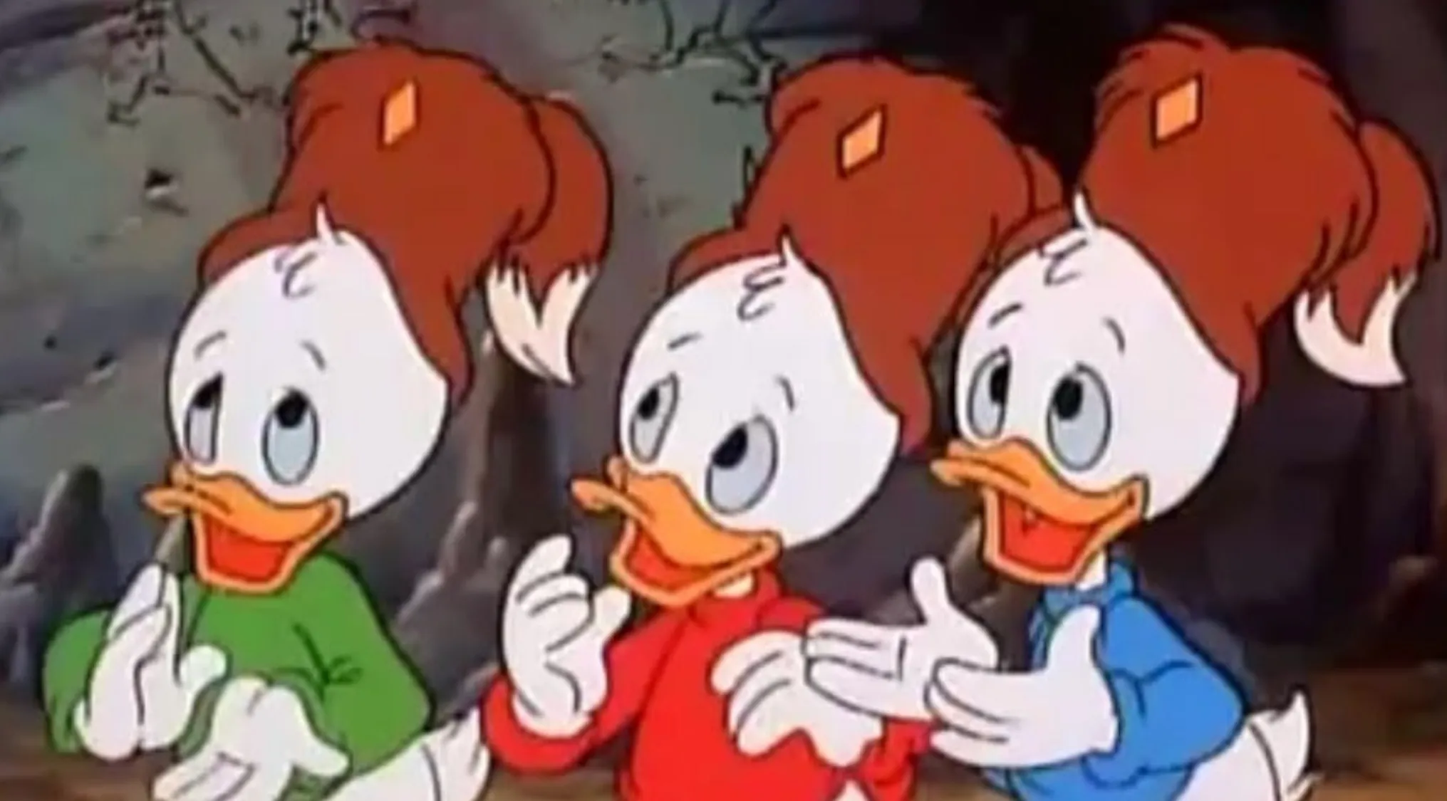 Three animated duck characters in bonnets, wearing green, red, and blue shirts, engaging in Saturday morning cartoons trivia.
