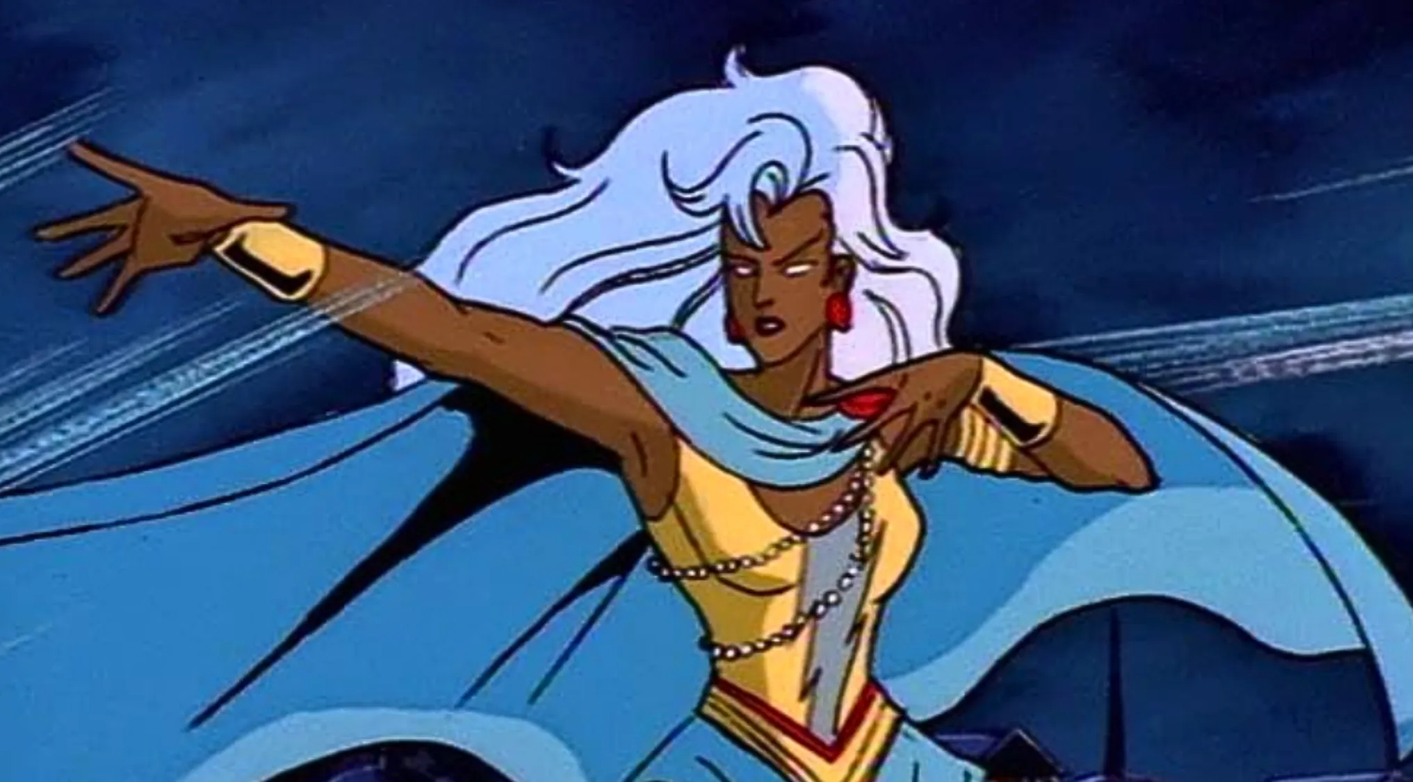 An animated X-Men character, Storm, with long white hair and a blue cape, striking a powerful pose. Saturday Morning Cartoons Trivia.