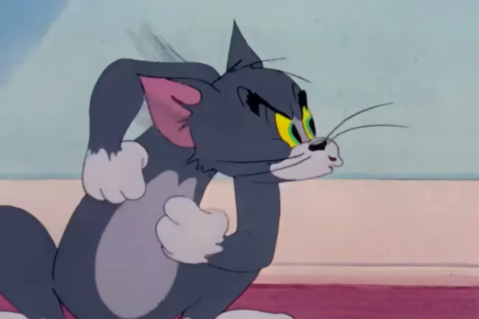 Tom the cat, with a menacing look and fists clenched, ready to face his nemesis.