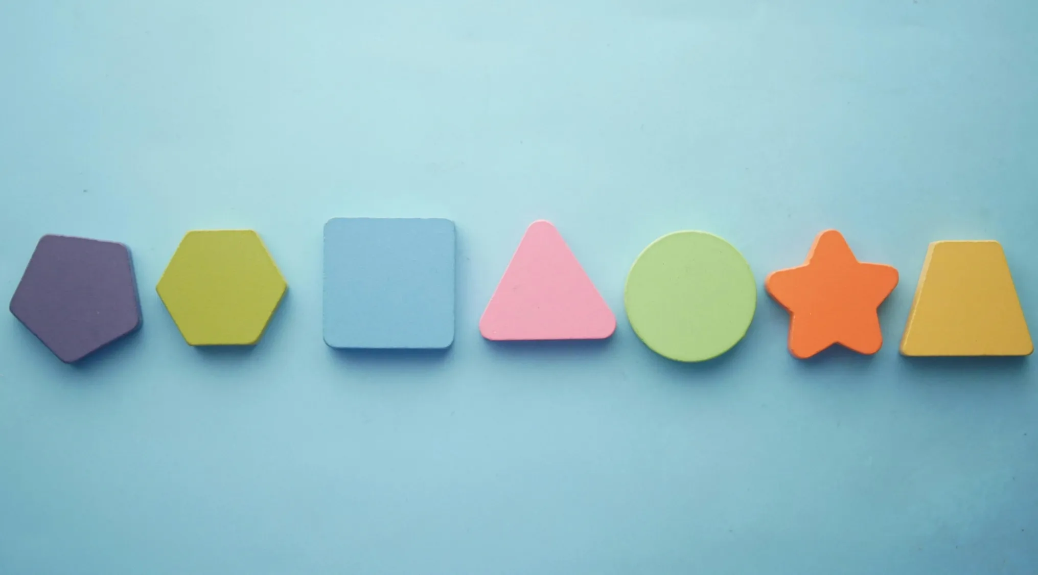 Colorful geometric shapes: pentagon, hexagon, square, triangle, circle, star, and trapezoid. Geometry fun facts.