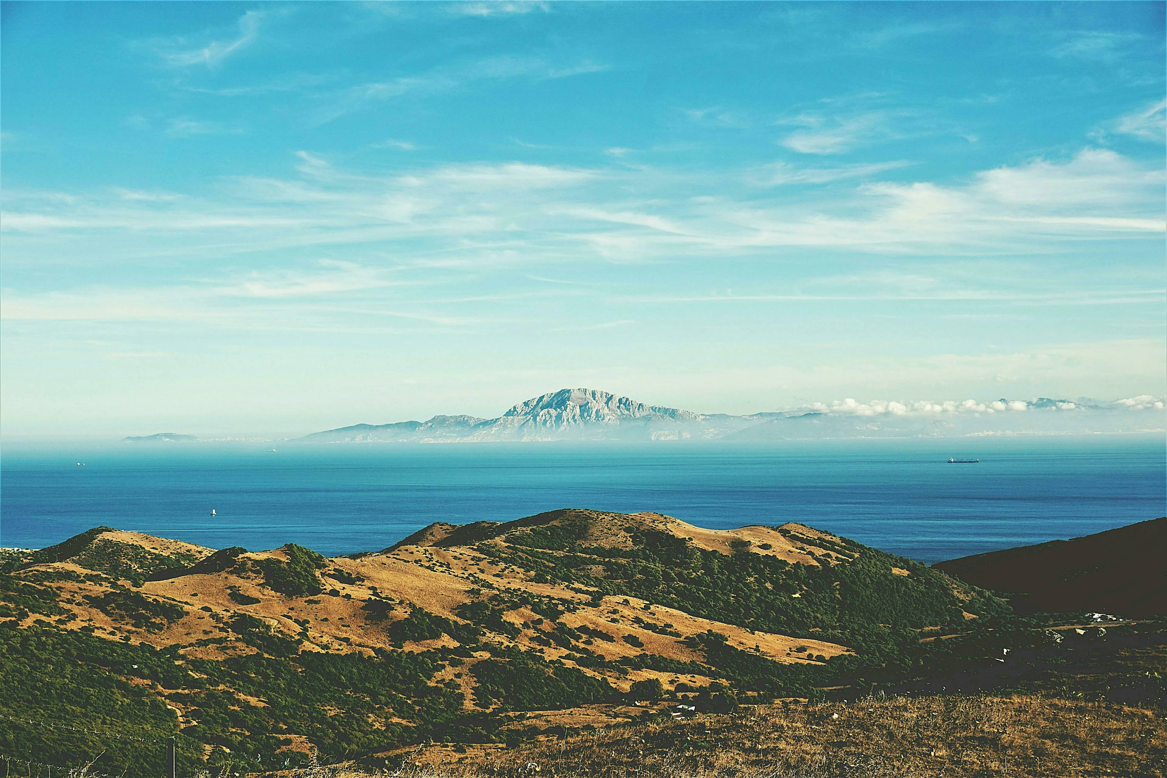 Strait of Gibraltar with blue sky, ocean, and distant land, completing the geography fact about Spain and Africa.