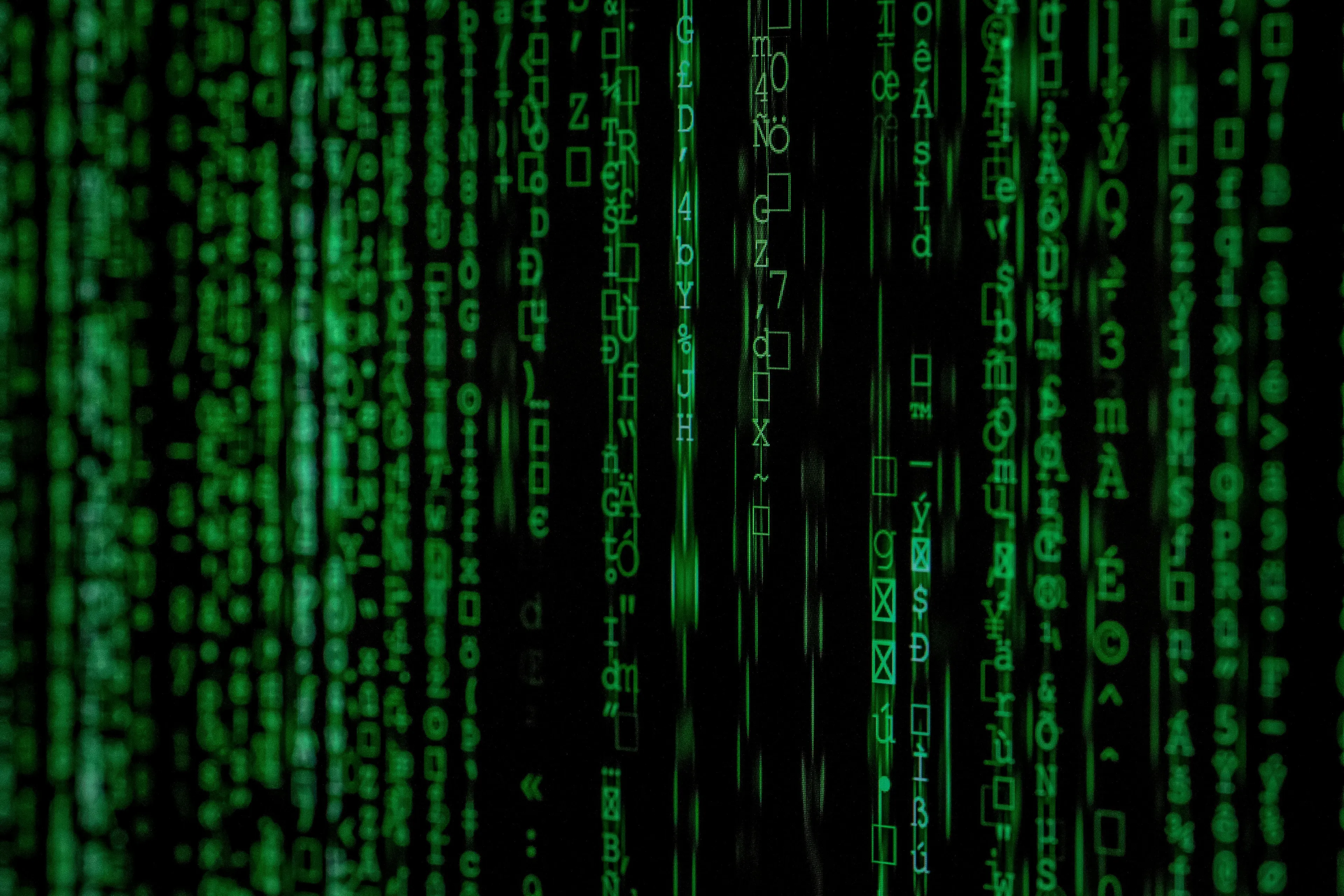 Cascading green Matrix code on a black background, representing a film's digital reality.