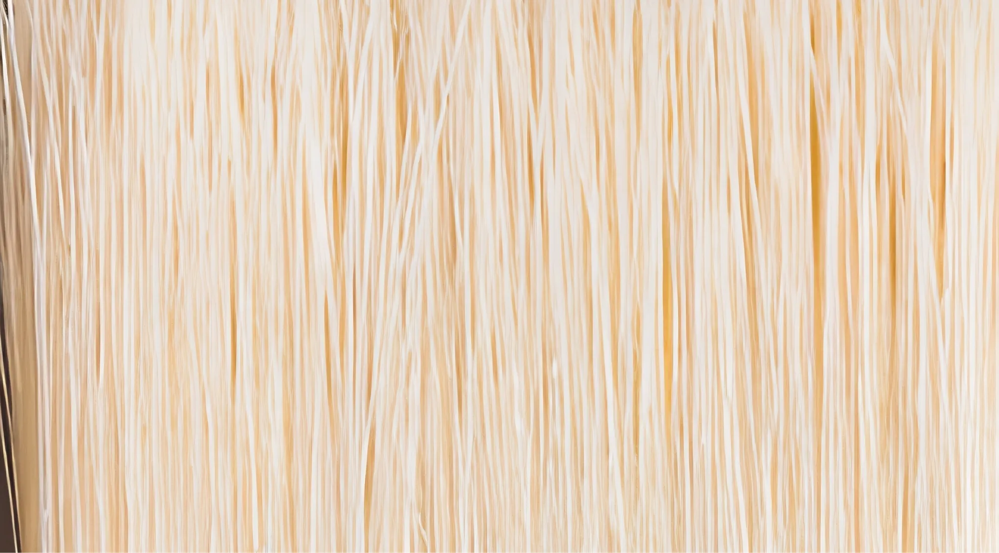Zoomed-in images of many thin, light-colored threads or strands hanging down, creating a uniform texture.