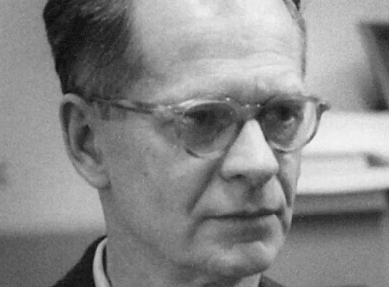 Black and white close-up of B.F. Skinner, a male thinker with glasses and a serious expression, looking forward.