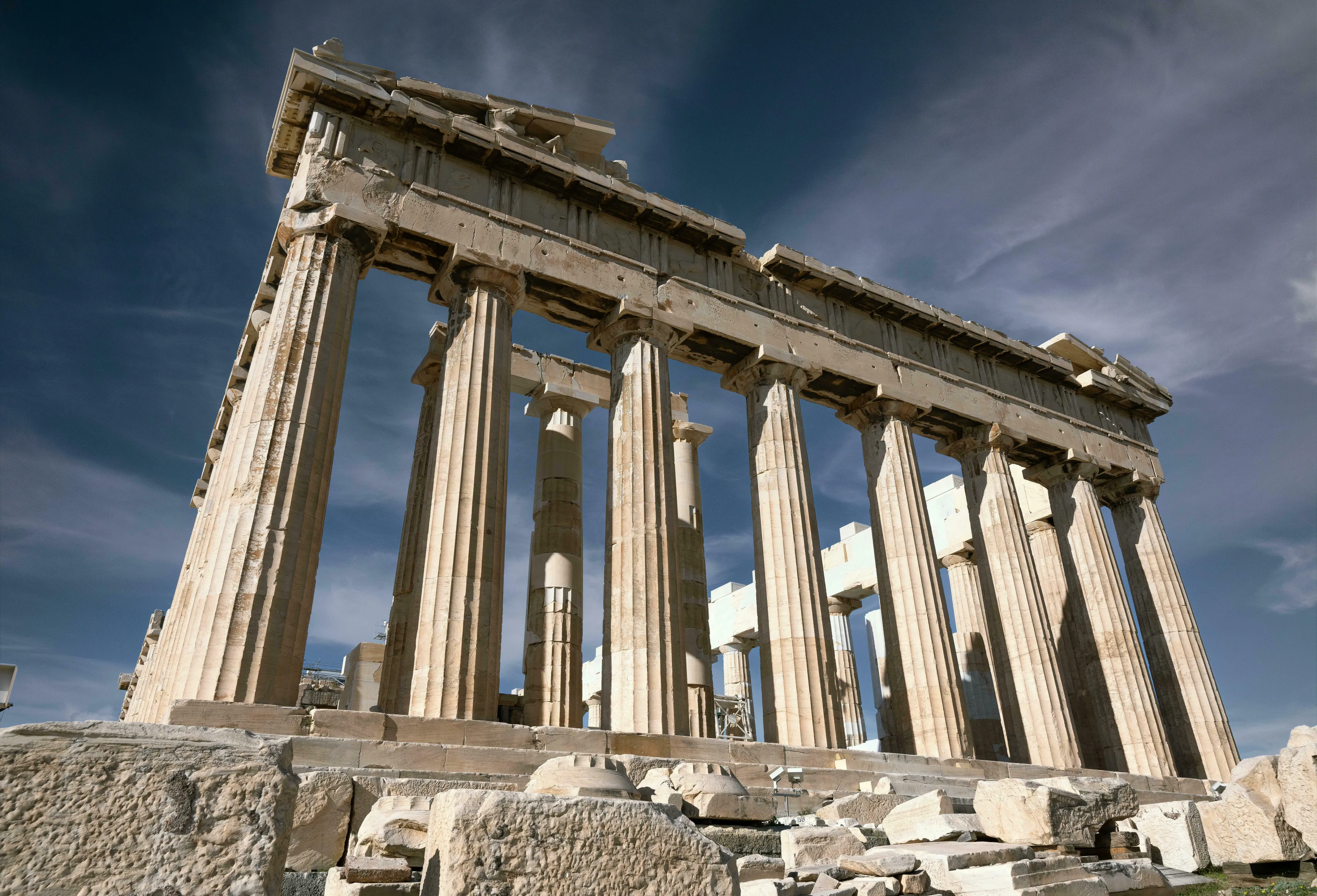 The ancient citadel of Acropolis, Athens with The Parthenon's grand columns under a deep blue sky. General Knowledge A-Z.