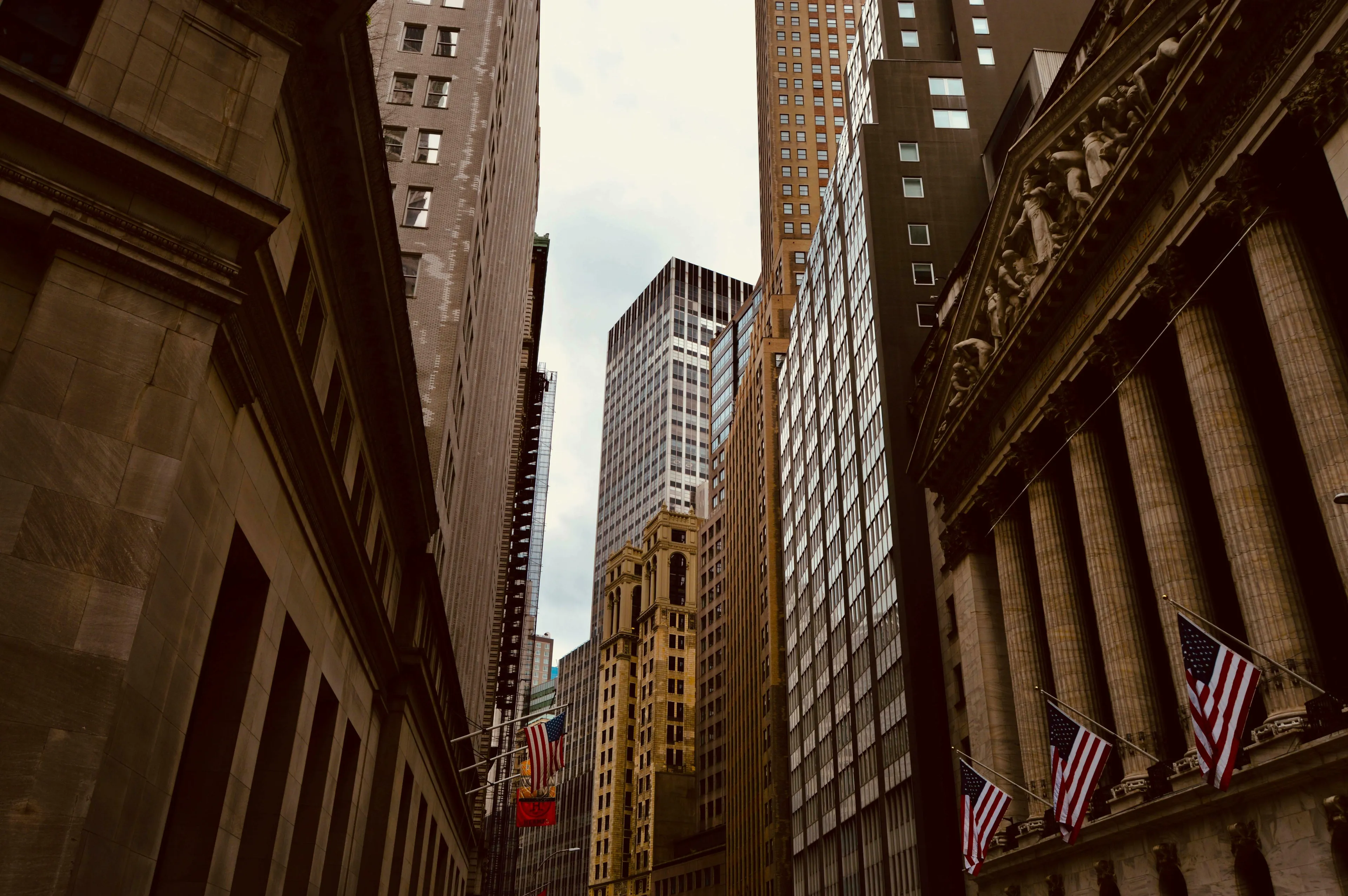 Tall buildings in the historic financial district of New York, featuring the iconic columns of global finance institutions.